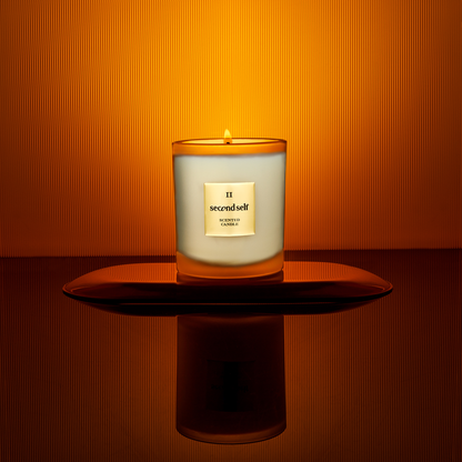 The Second Self candle from the Second Self Collection displayed on a pedestal, set against a backdrop with an ombre effect.